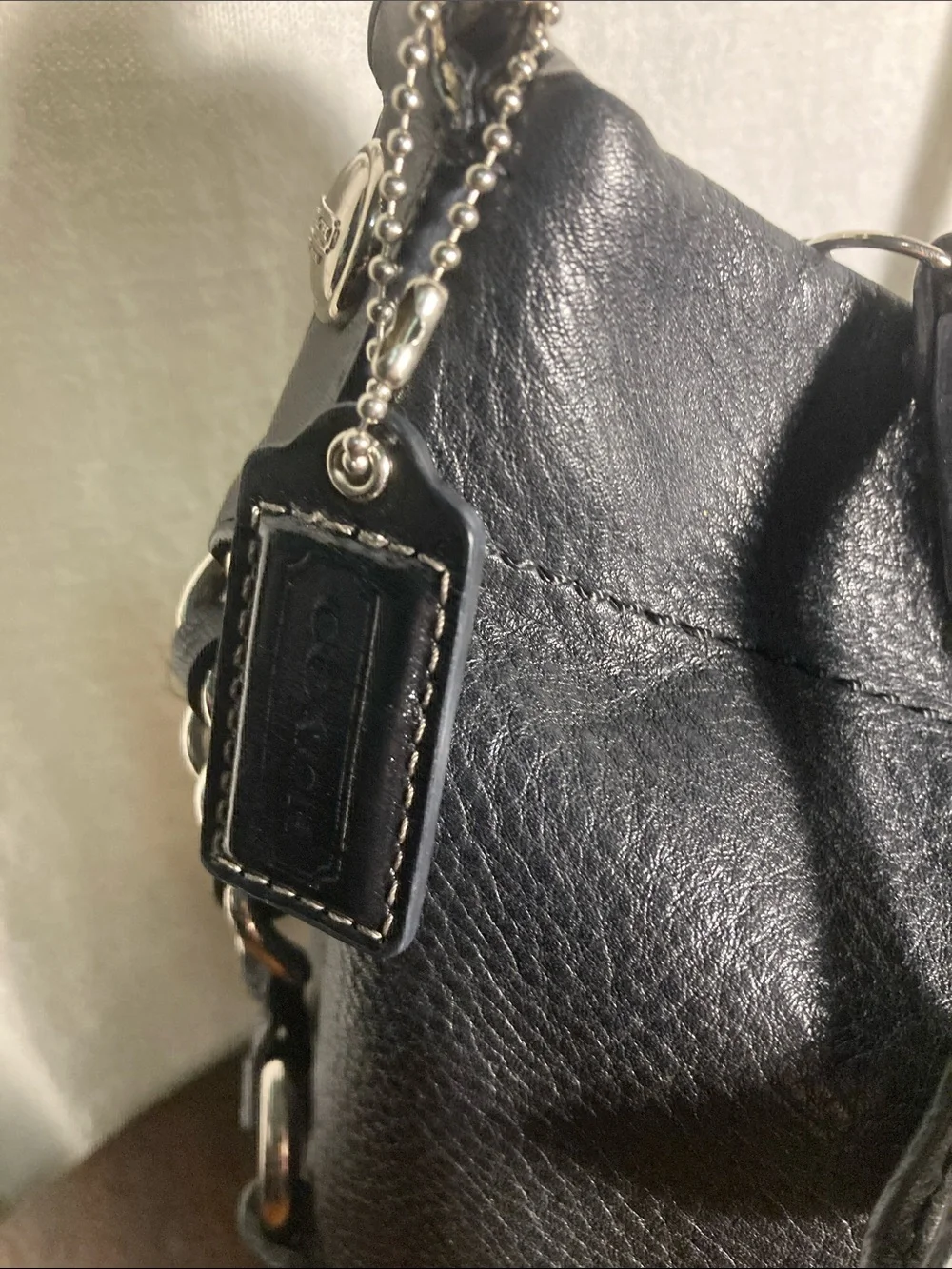 Coach black pebbled leather Carly hobo shoulder bag with silver hardware.